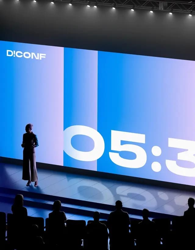 Conference stage with a countdown on screen
